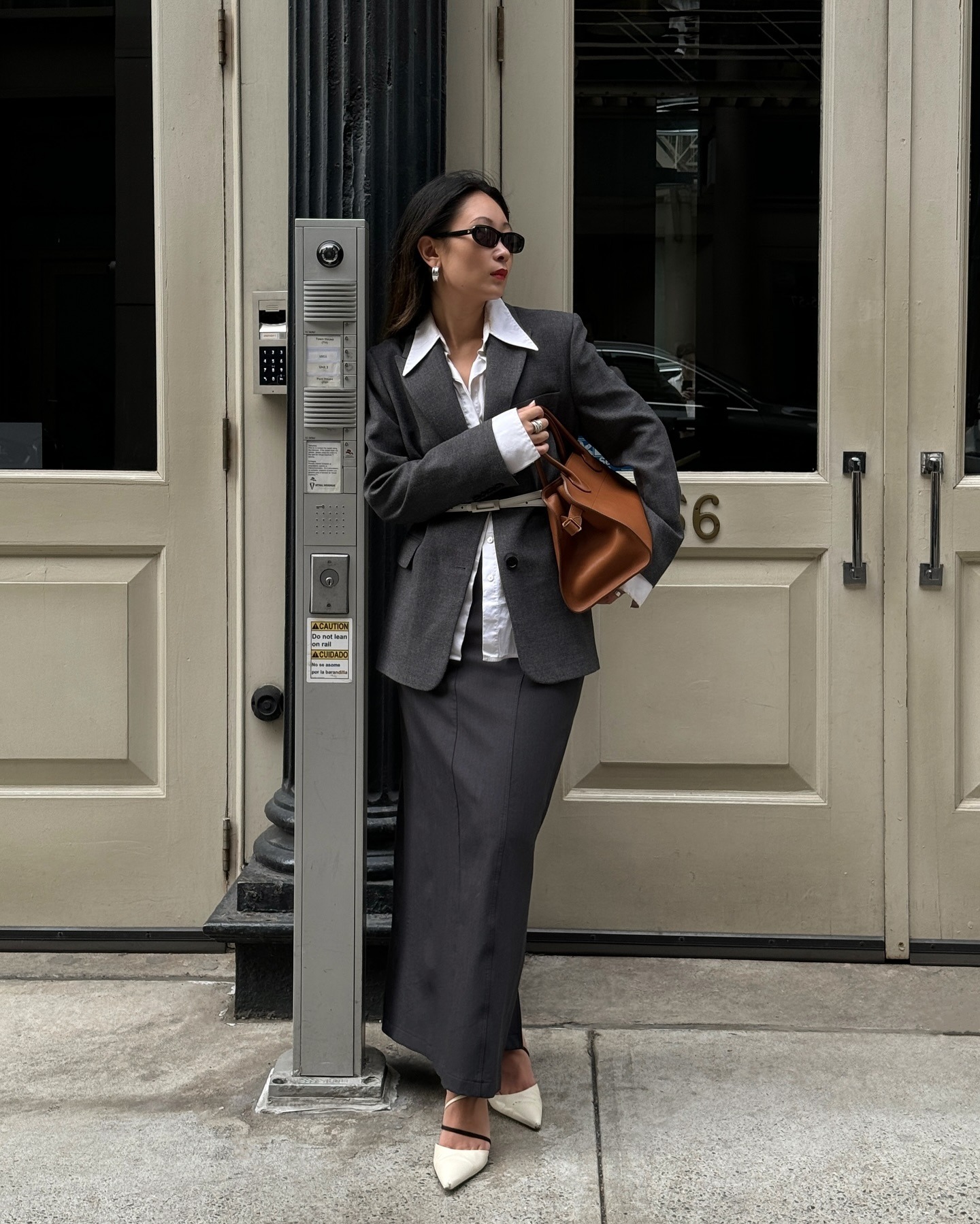 Influencer @dawn.tan wears a grey blazer and skirt with white heels.
