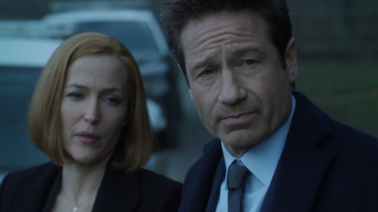 Gillian Anderson's Dana Scully and David Duchovny's Fox Mulder observe something offscreen in season 11 on The X-Files