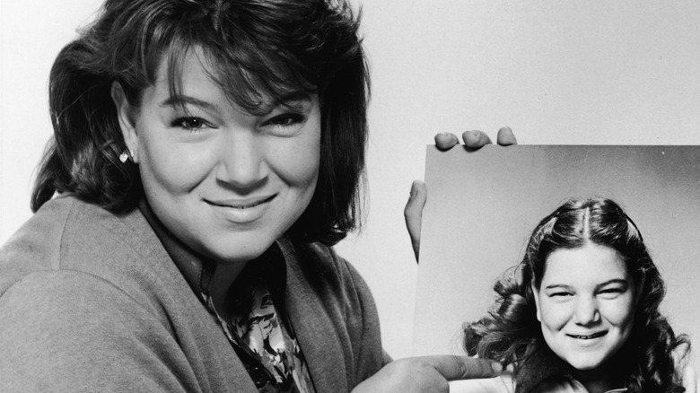 Mindy Cohn holds a photo of her younger self as Natalie Green from 