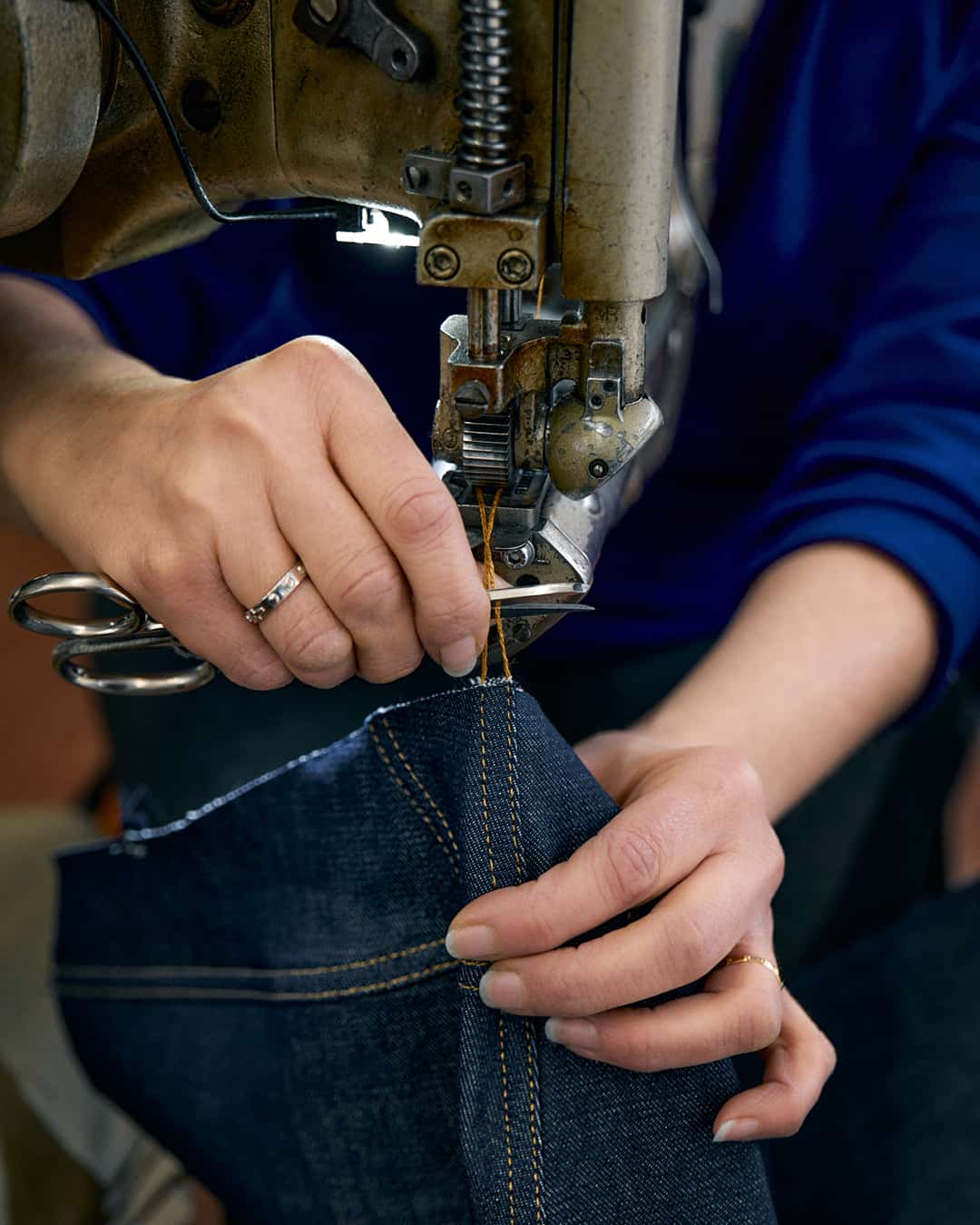 tailor making a pair of jeans