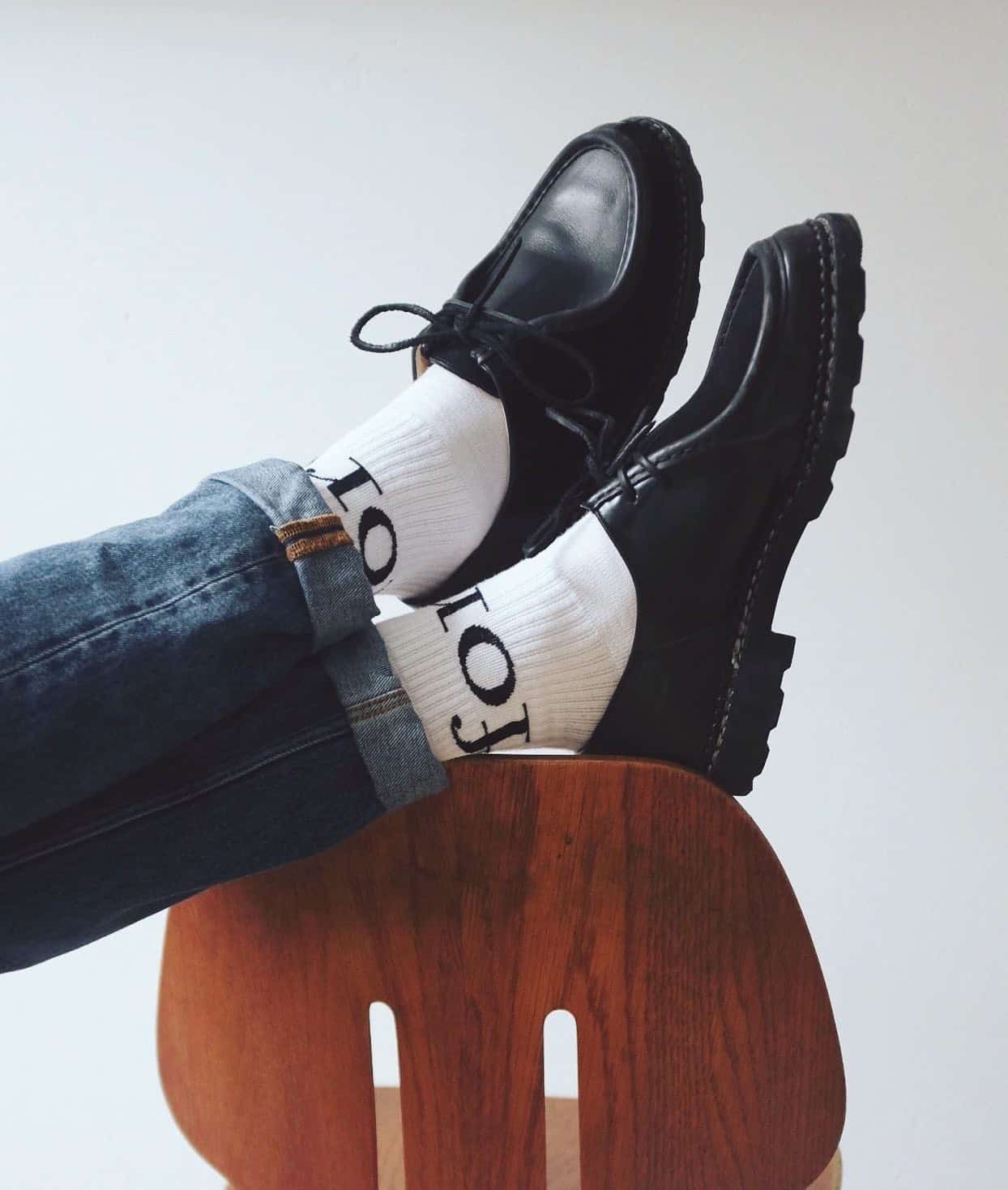 resting both feet on top of a chair backrest